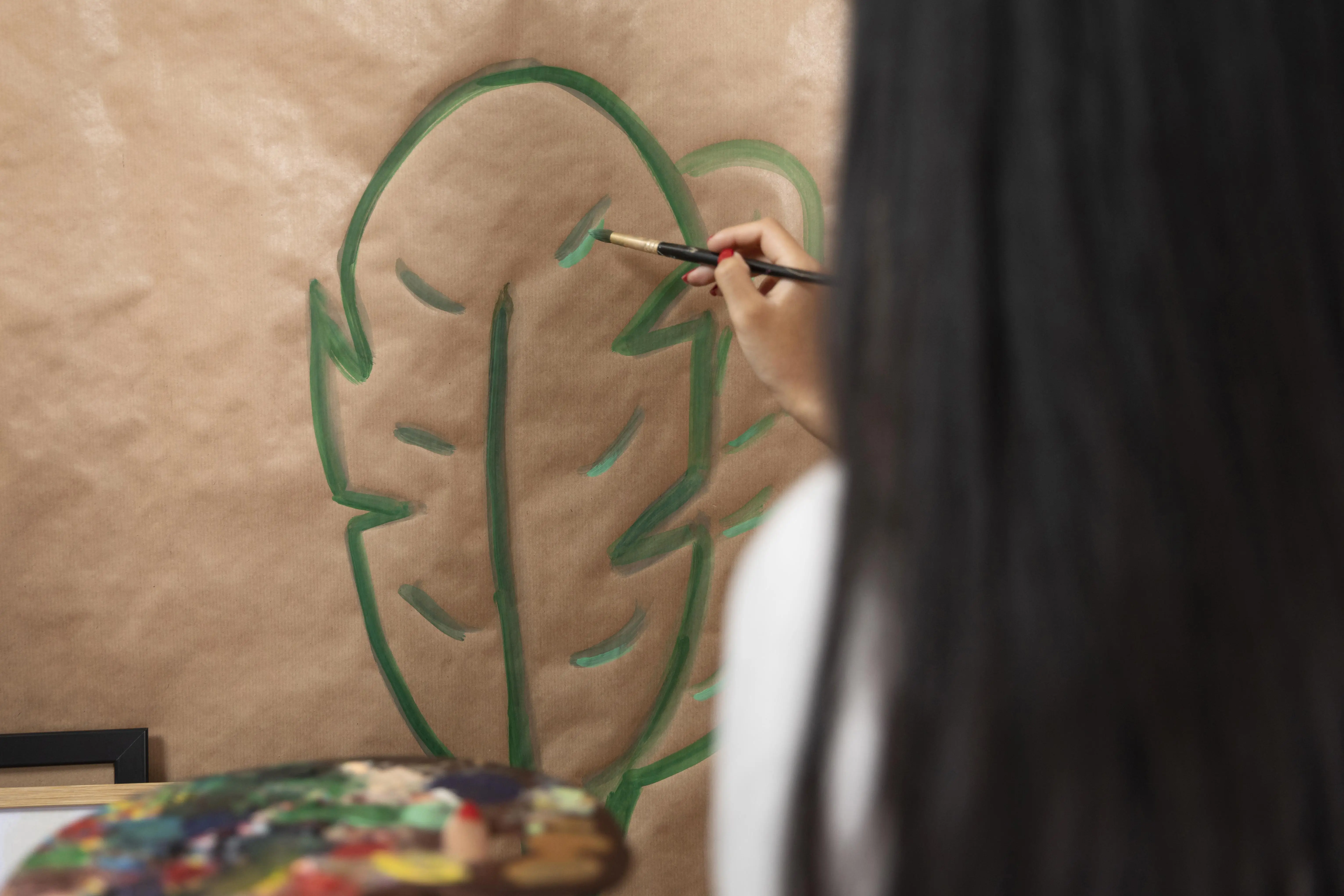 close-up-woman-painting-leaf